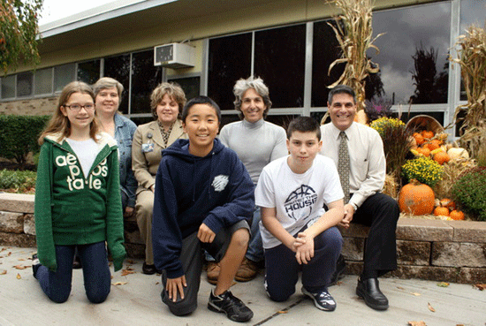 Fifth grader Emily McCausland, Board of Education Trustee Bernadette McCausland, West Brook Principal Carla Alvarez, eighth grader Kohei Ito, landscaper Dennis Ferraioli, fifth grader Anthony Ferraioli and vice principal Larry Calenda in front of decorations that Dennis Ferraioli donated to the school, Oct. 20, 2011.